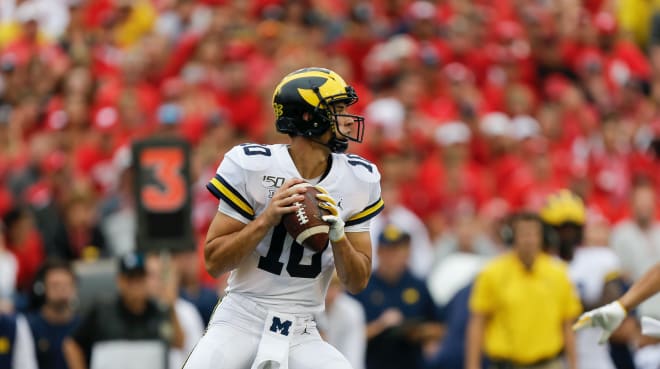 Michigan Wolverines football quarterback Dylan McCaffrey drops back to throw