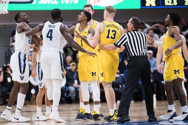 The Michigan Wolverines and Villanova Wildcats in an altercation during a 2018 basketball game.