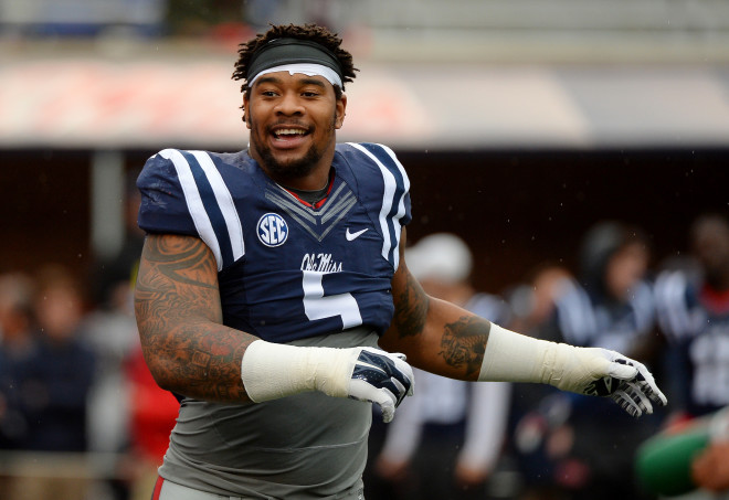 In this Nov. 7, 2015, file photo, Ole Miss defensive tackle Robert Nkemdiche stretches before an NCAA college football game against Arkansas in Oxford, Miss. Nkemdiche, who was recently charged with marijuana possession after a 15-foot fall at an Atlanta hotel, will not play in the Sugar Bowl against Oklahoma State on Jan. 1, 2016, and will enter the NFL draft as a junior.