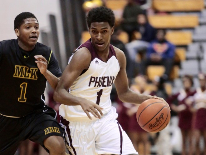 Detroit Renaissance senior combo guard Justin Turner dribbles past a defender.