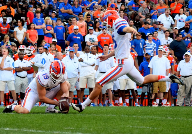 Florida kicker Eddy Pineiro (right) attempts a field goal during the Orange & Blue Debut on April 8.