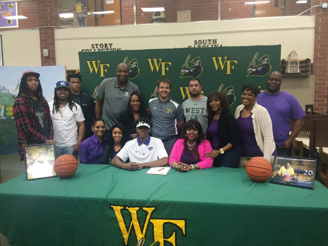 Cartier Diarra was surrounded by friends and family as he signed his letter of intent with Kansas State on Wednesday.
