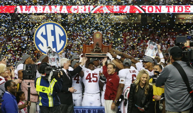 Bill Battle and Nick Saban celebrate with the SEC championship trophy after Alabama beat Missouri by a score of 42-13 at the Georgia Dome in Atlanta, Ga. on Saturday Dec. 6, 2014.