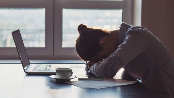 woman with head on desk