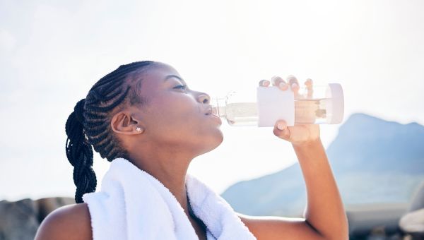 Woman drinking from bottle of water