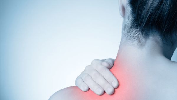 Woman rubbing neck muscle, neck pain