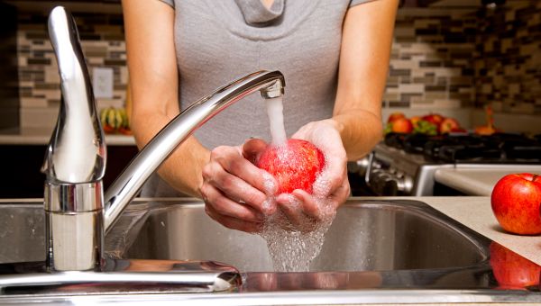 woman washing apples, sink, kitchen, water