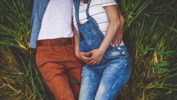 man and woman in a field, pregnant woman, overalls