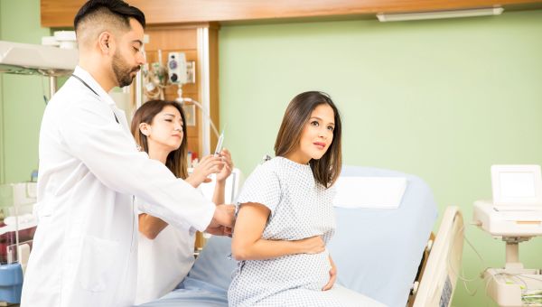 Pregnant woman getting epidural before giving birth