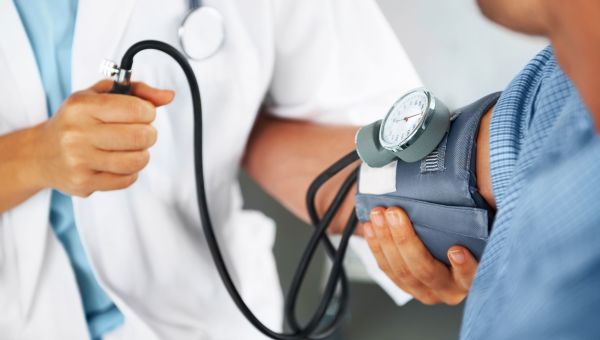 doctor listening to a patient's heartbeat with a stethoscope