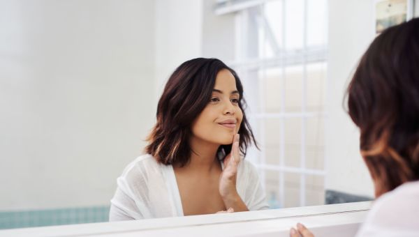 woman looking in mirror