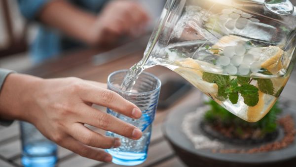 Person pouring water from pitcher