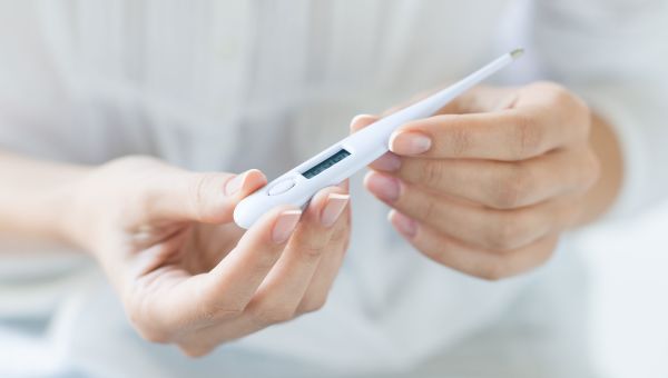 checking temperature with thermometer