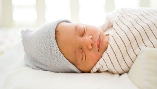 baby sleeping wrapped in blanket