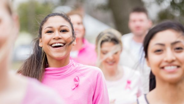 Woman smiling during breast cancer charity run