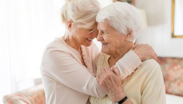 elderly woman hugging her mom