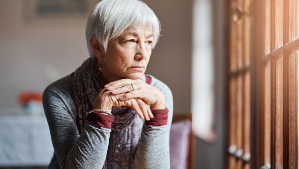 mature woman staring out window