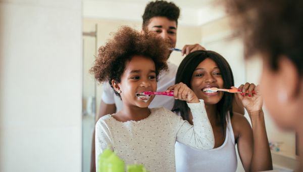 family brushing their teeth