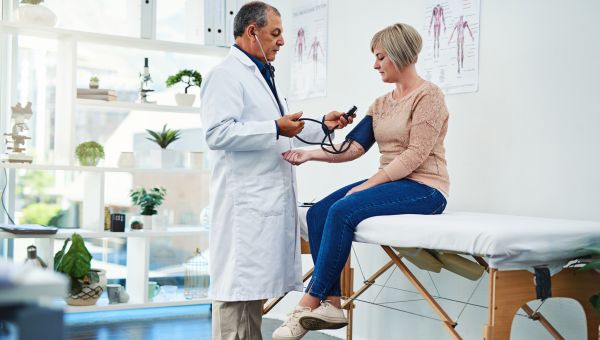 doctor checking blood pressure