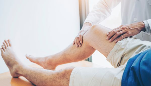 doctor assessing knee pain