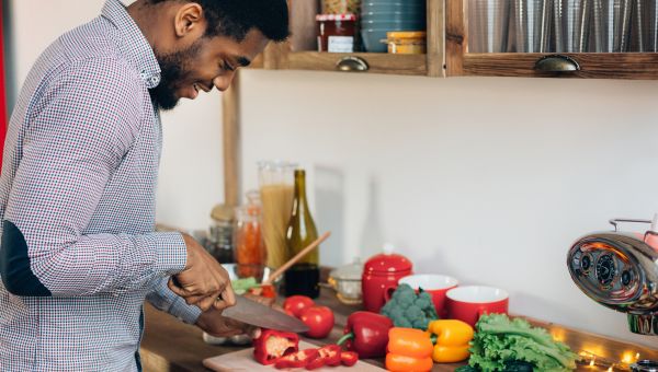 young man chopping vegetables