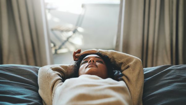 young woman lying on her back