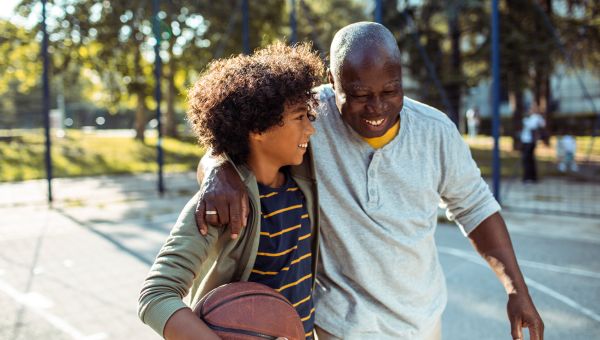 grandfather playing basketball with grandson