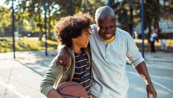 grandfather playing basketball with grandson