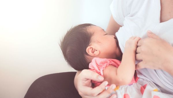 A woman breastfeeding her baby.