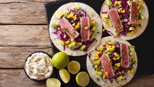 open-faced tuna tostada sandwiches with a variety of fresh toppings