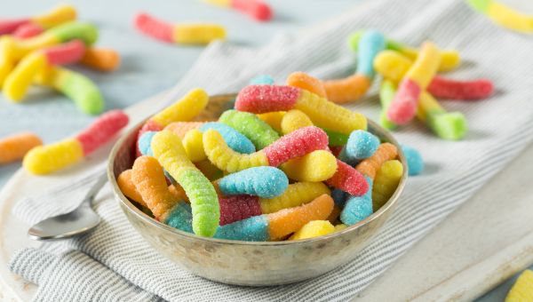 a bowl of sour gummy worm candy