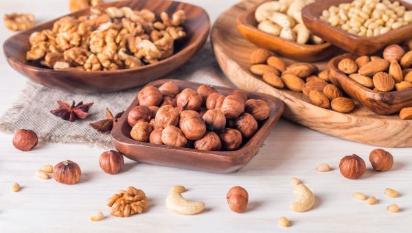 Bowls filled with various nuts, which is a vital part of any paleo diet.