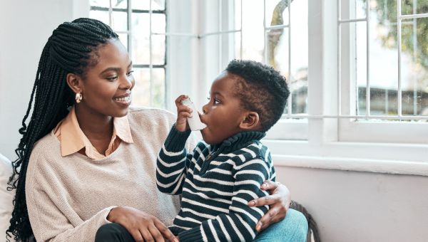 mom with son using inhaler