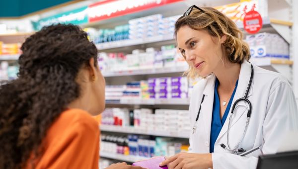 young woman talking to pharmacist