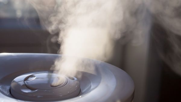 a humidifier running in a room to help prevent dry skin