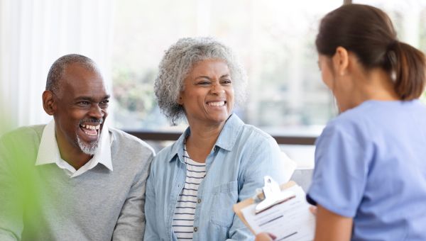 older couple smiling together while at healthcare appointment