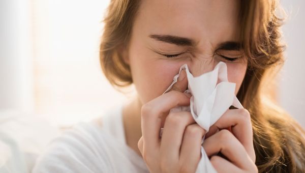 woman blowing nose, tissue