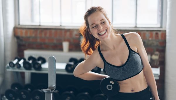 woman laughing in a weight room