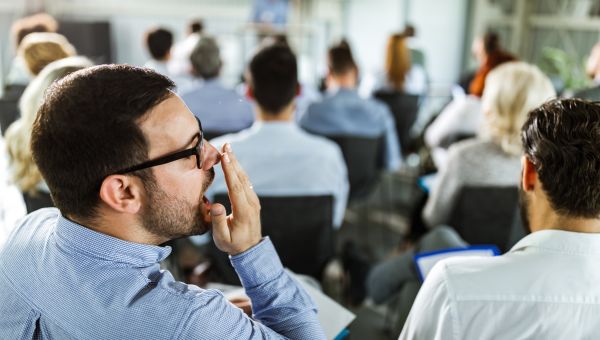 man checking his breath at work