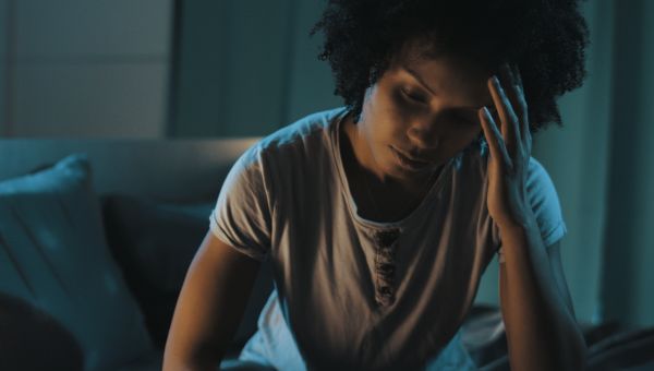 young woman in bed tired