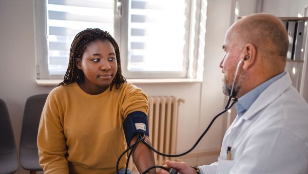 Healthcare provider measuring blood pressure of someone