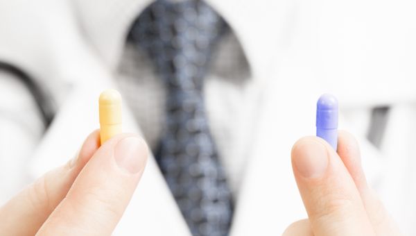 doctor holding two types of osteoporosis medication