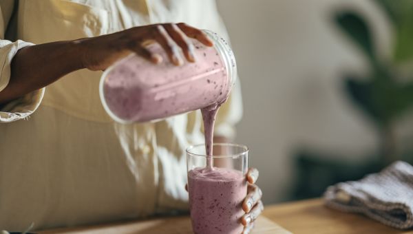 young woman making a smoothie