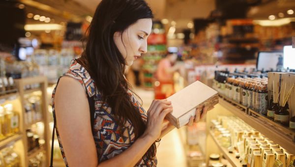 A young woman browsing incense in a shopping mall