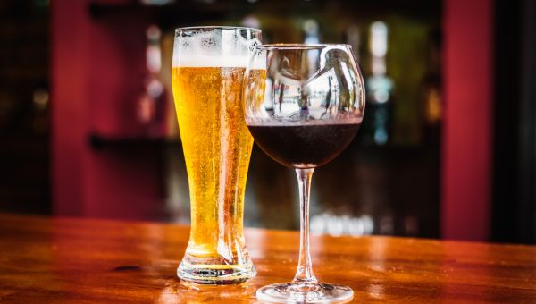 glass of beer and wine on top of a bar