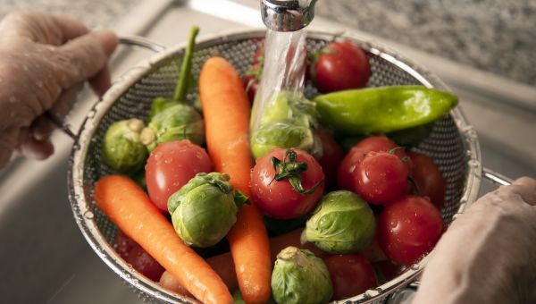 washing vegetables in the sink