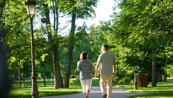 happy couple walking in park