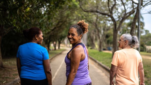 three mature women walking together for exercise