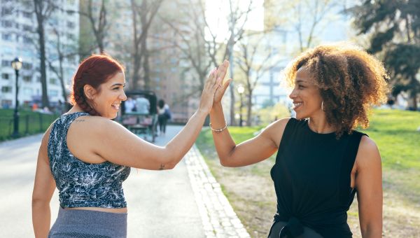 two people high fiving each other
