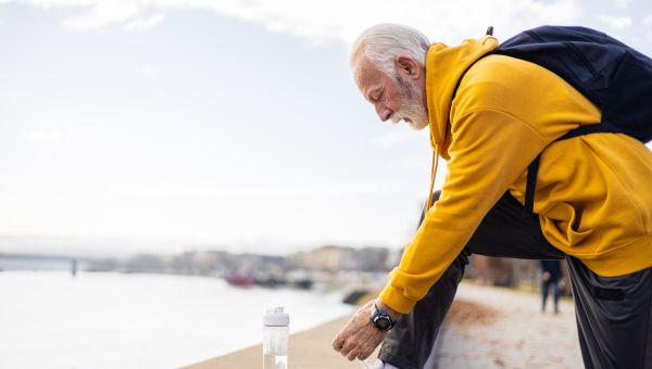 someone tying their shoe and getting ready to exercise